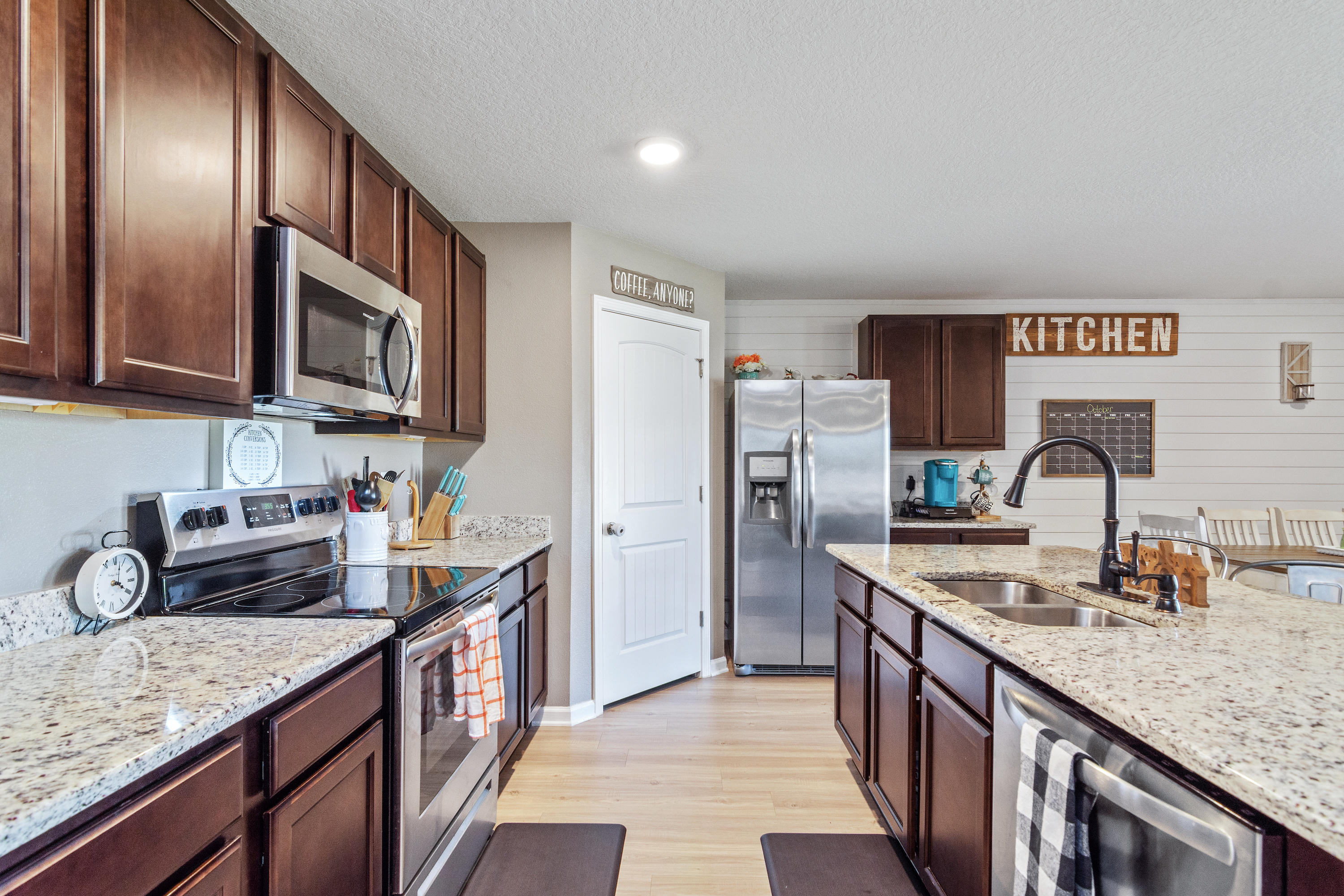 501 Merganser Way Crestview, FL 32539 - Photo 6 of 34 a kitchen with stainless steel appliances granite countertop a sink stove and refrigerator