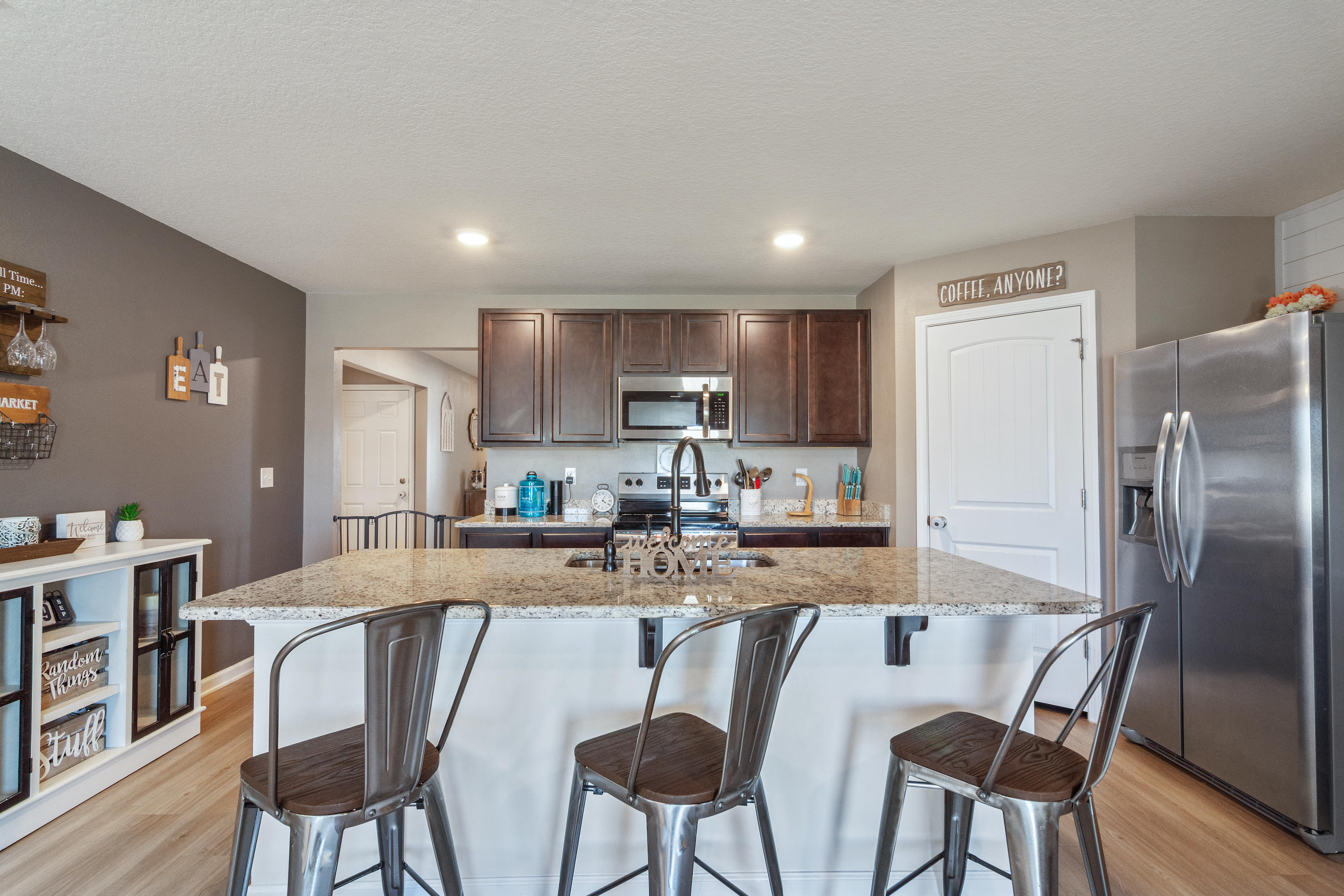 501 Merganser Way Crestview, FL 32539 - Photo 7 of 34 a kitchen with refrigerator and chairs