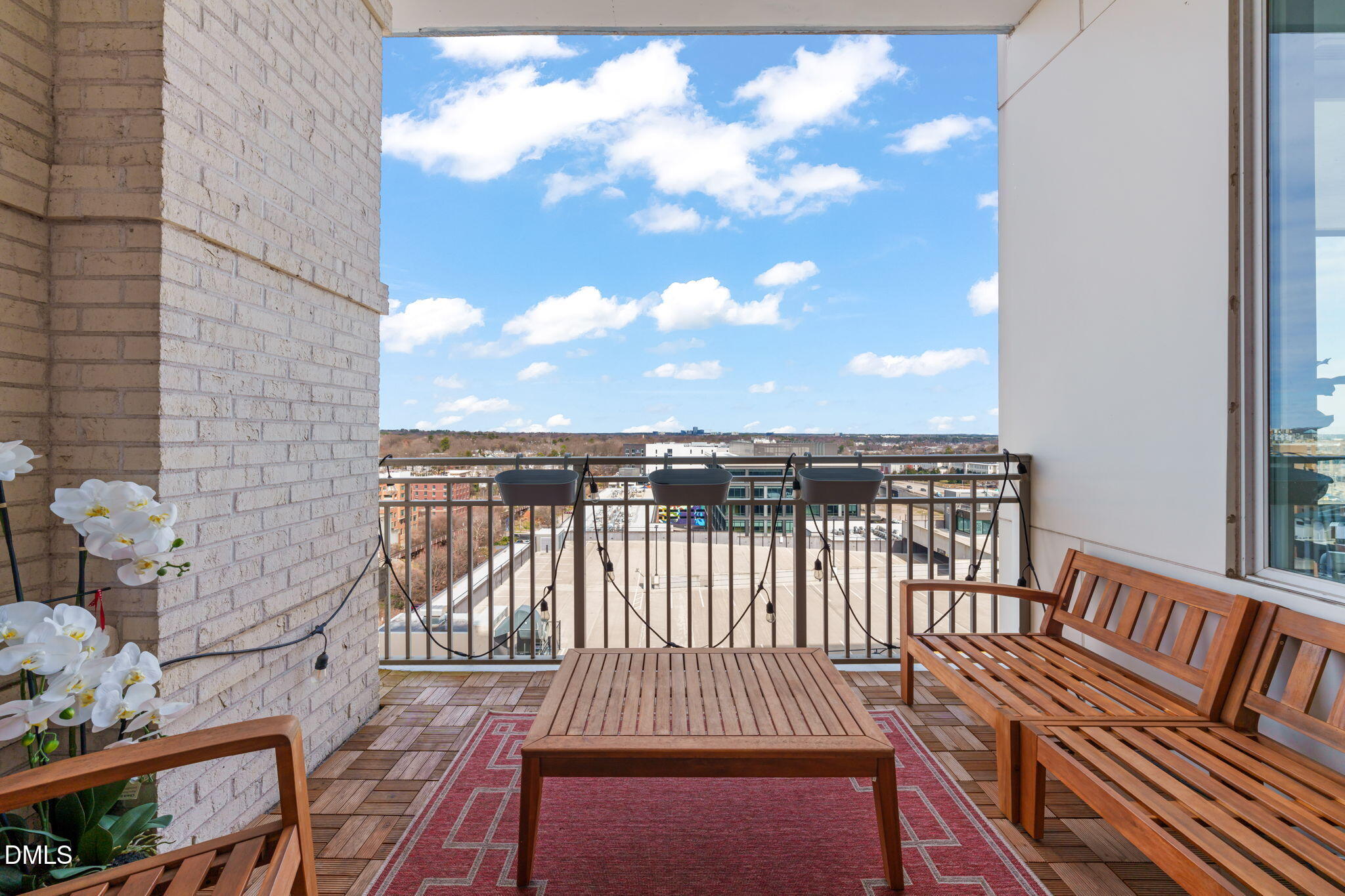 400 West North Street, Unit 1218 Raleigh, NC 27603 - Photo 27 of 41 a view of a roof deck with wooden floor and city view
