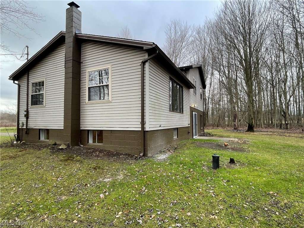 6135 California Road Williamsfield, OH 44093 - Photo 35 of 37 View of side of home featuring a yard