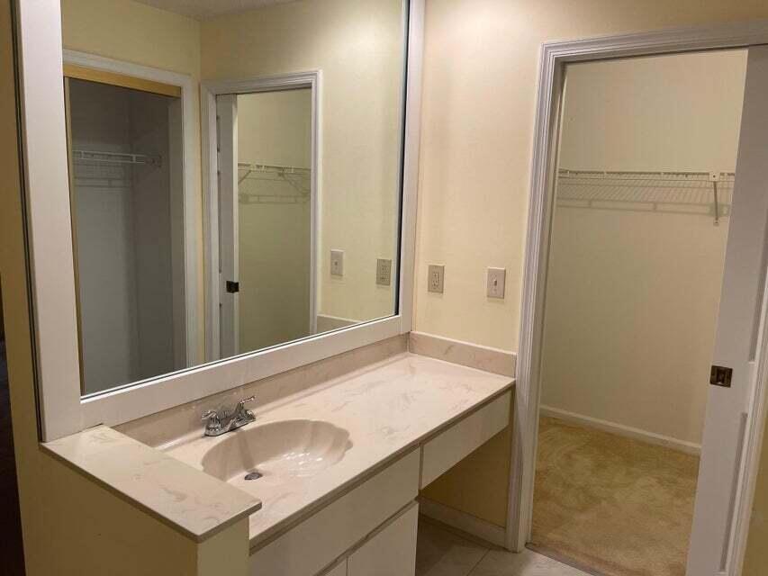 7722 Solimar Circle Boca Raton, FL 33433 - Photo 22 of 36 a bathroom with a sink and a mirror