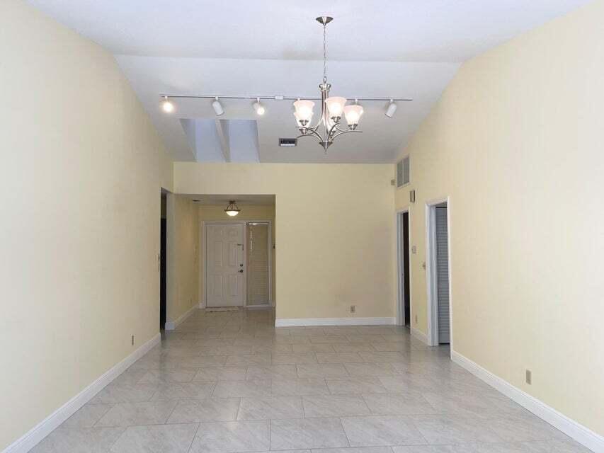 7722 Solimar Circle Boca Raton, FL 33433 - Photo 27 of 36 a view of a chandelier and chandelier in hallway