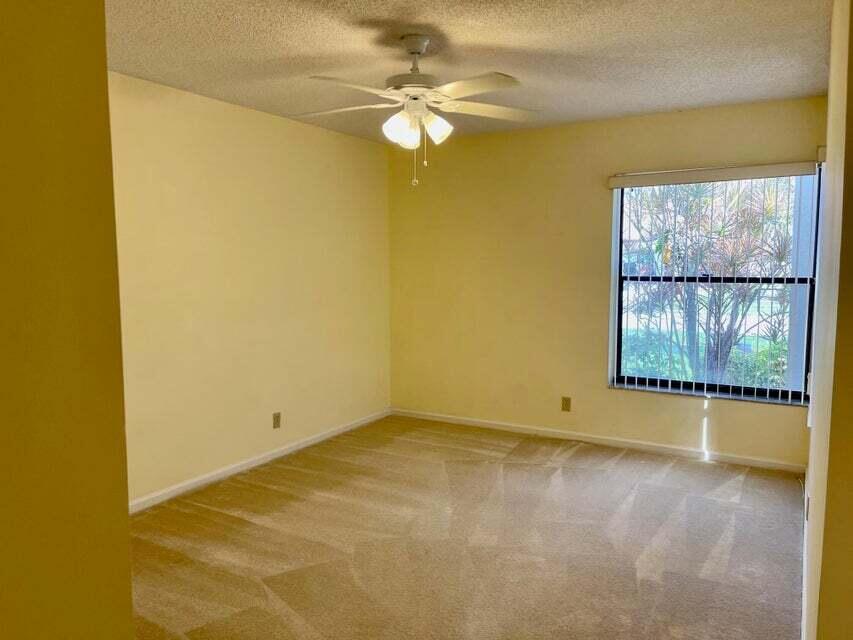 7722 Solimar Circle Boca Raton, FL 33433 - Photo 30 of 36 an empty room with windows and ceiling fan