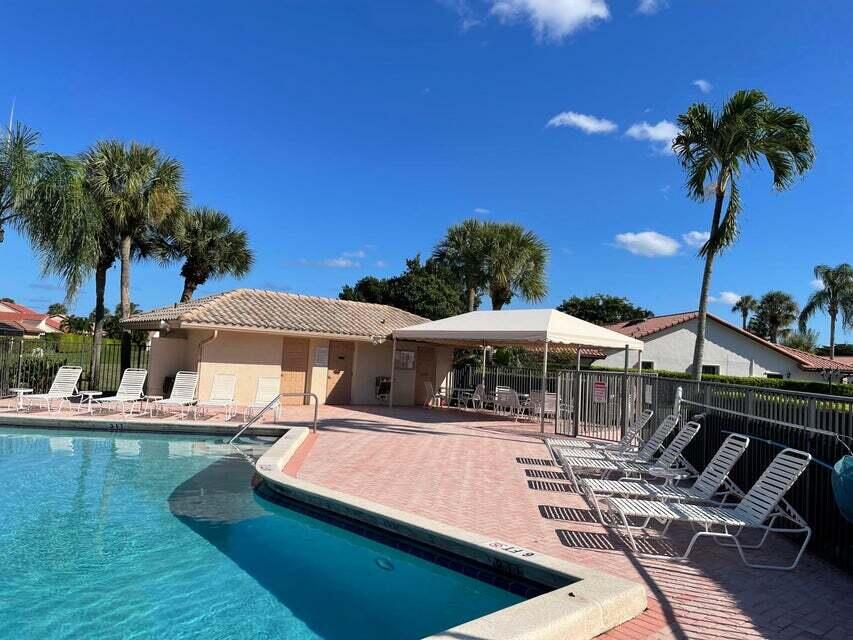 7722 Solimar Circle Boca Raton, FL 33433 - Photo 35 of 36 a view of a patio with swimming pool table and chairs