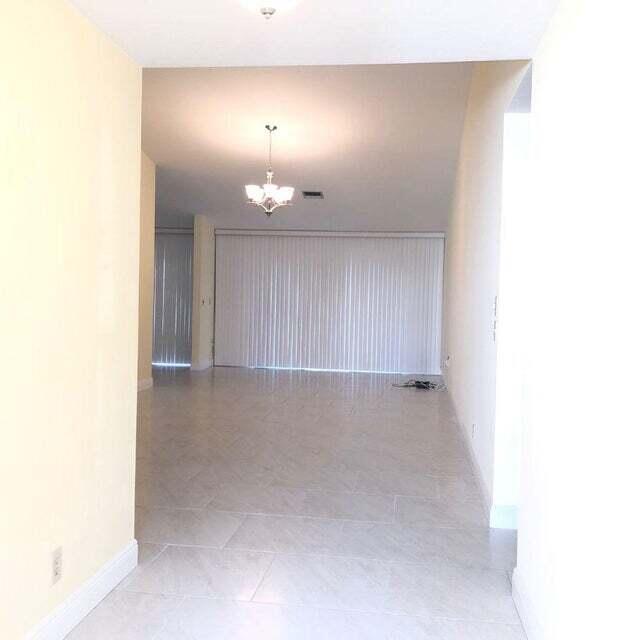 7722 Solimar Circle Boca Raton, FL 33433 - Photo 4 of 36 a view of an empty room with a chandelier fan