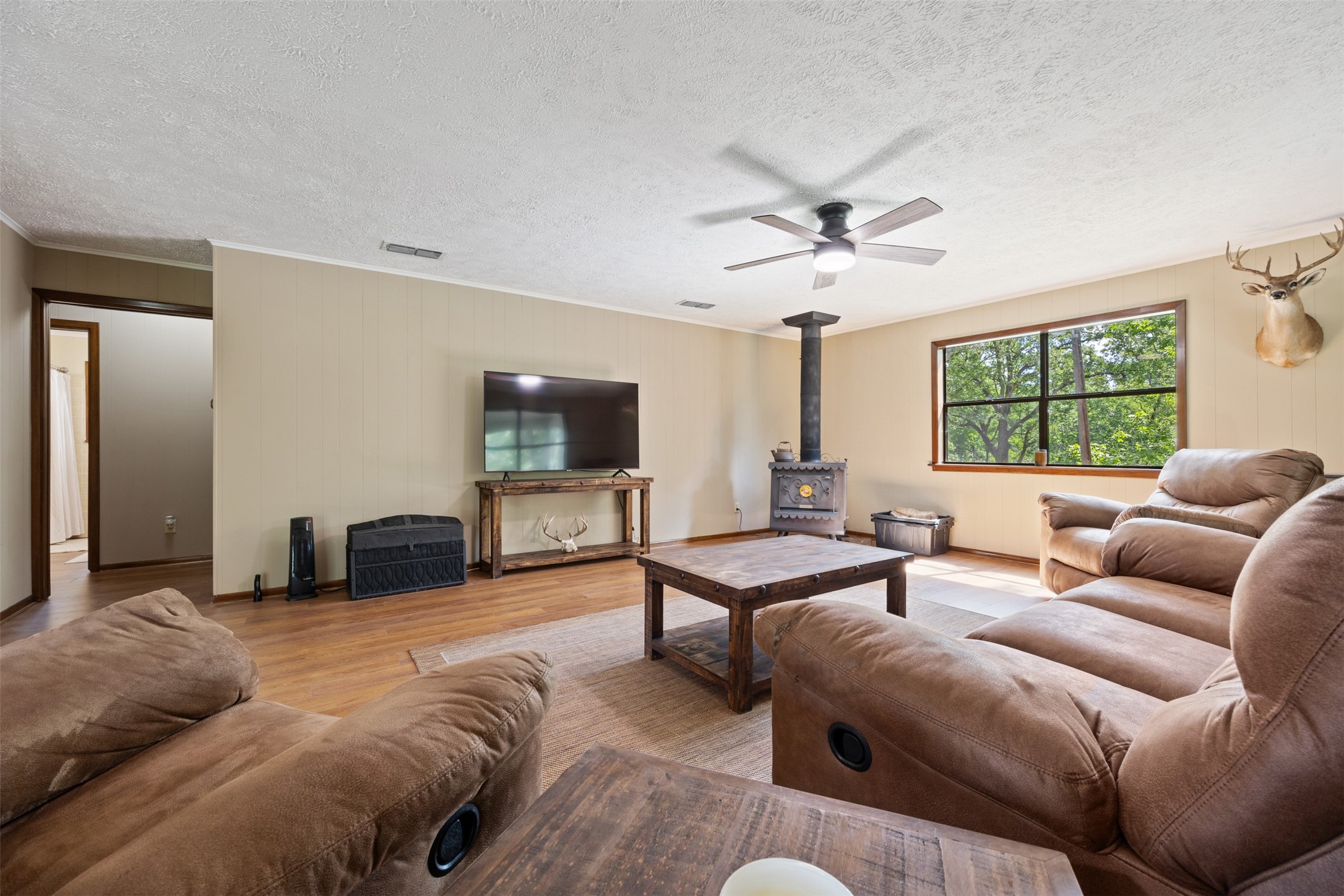 729 Centerhill Cemetery Road Crockett, TX 75835 - Photo 25 of 43 a living room with furniture a large window and a flat screen tv