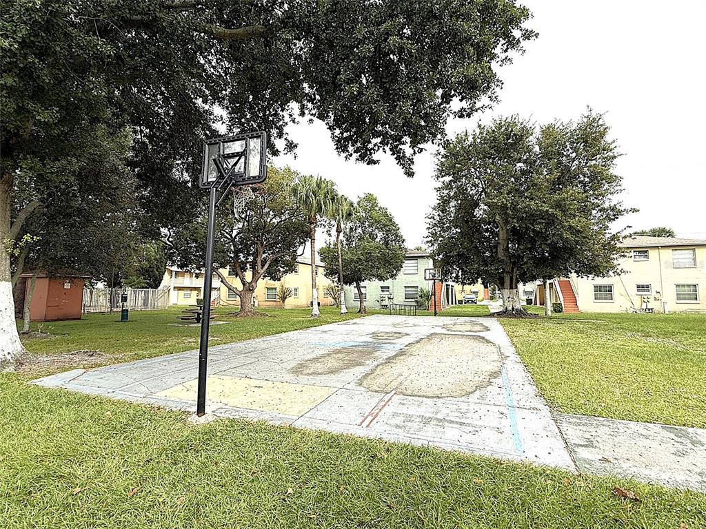 698 Michigan Court, Unit 4 St. Cloud, FL 34769 - Photo 17 of 17 a view of a yard with palm trees