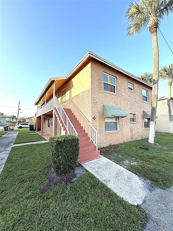 698 Michigan Court, Unit 4 St. Cloud, FL 34769 - Photo 2 of 17 a front view of a house with a yard