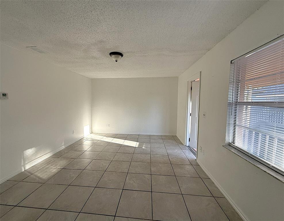 698 Michigan Court, Unit 4 St. Cloud, FL 34769 - Photo 7 of 17 a view of an empty room and window