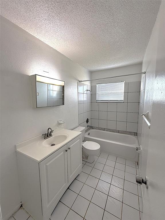 698 Michigan Court, Unit 4 St. Cloud, FL 34769 - Photo 10 of 17 a bathroom with a sink a toilet and mirror