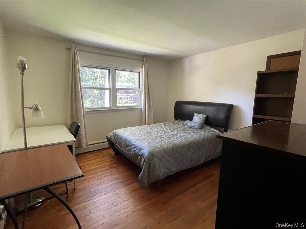 4 Cornwallis Road East Setauket, NY 11733 - Photo 14 of 16 a bedroom with a bed window and table