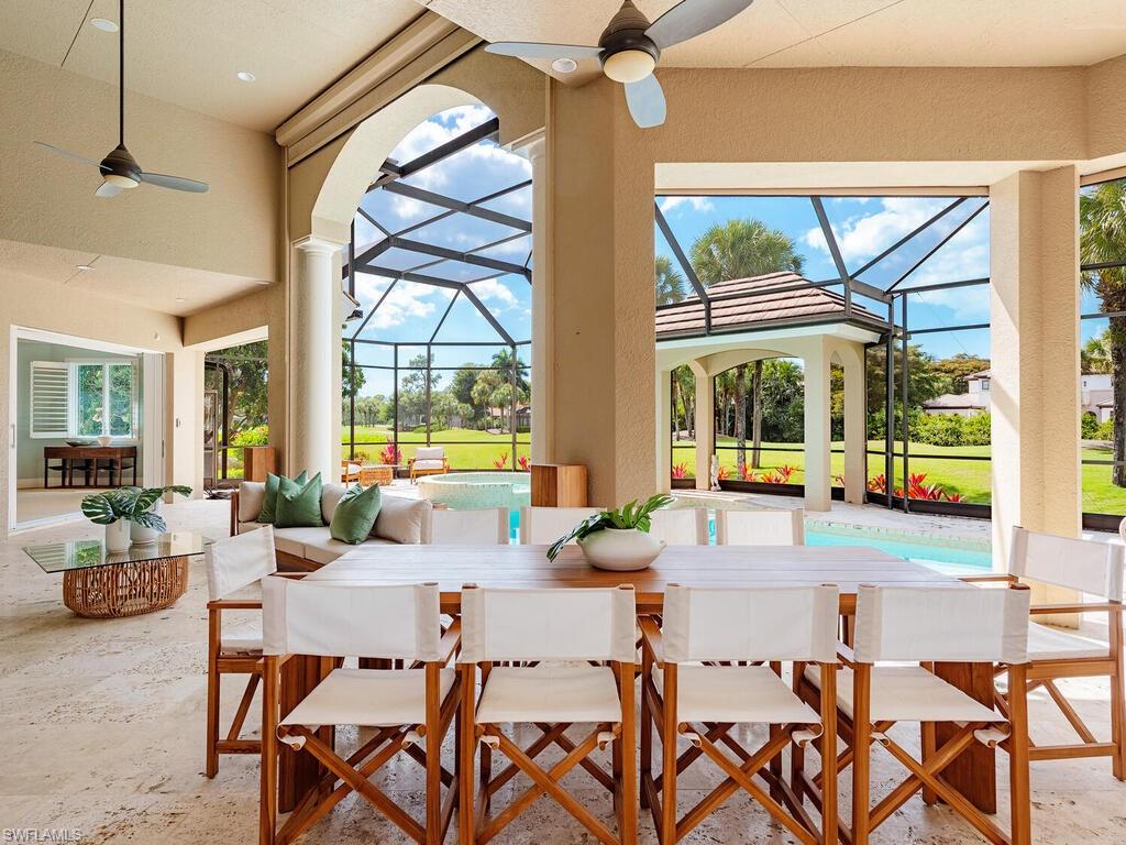 a living room with a large window and a chandelier