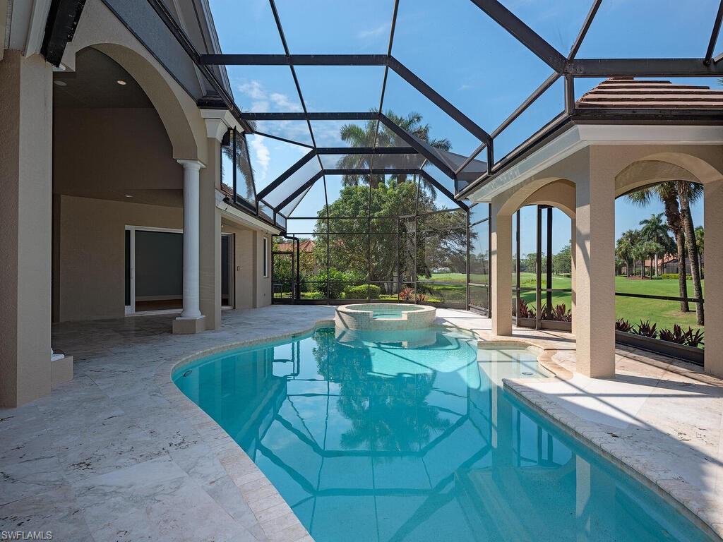 2835 Silverleaf Lane Naples, FL 34105 - Photo 15 of 47 a view of a swimming pool with a patio