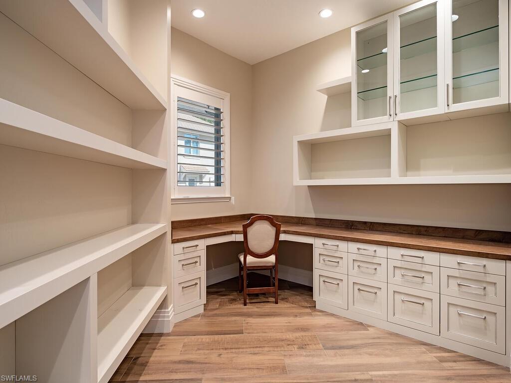 2835 Silverleaf Lane Naples, FL 34105 - Photo 22 of 50 a kitchen with a stove a sink and cabinets
