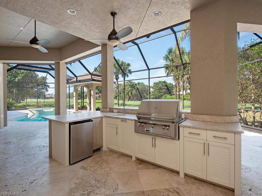 2835 Silverleaf Lane Naples, FL 34105 - Photo 23 of 47 a kitchen that has a sink and a stove