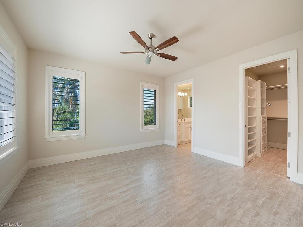 2835 Silverleaf Lane Naples, FL 34105 - Photo 24 of 50 wooden floor in an empty room with a window