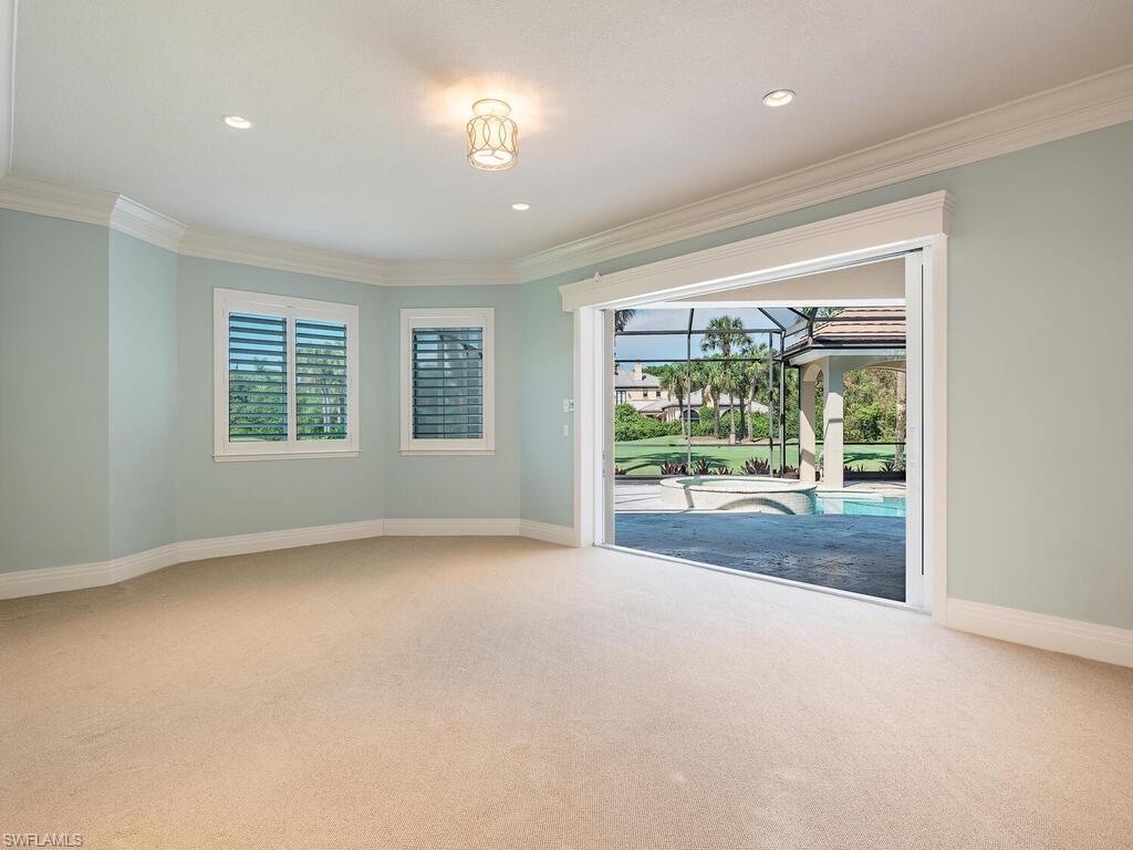 2835 Silverleaf Lane Naples, FL 34105 - Photo 27 of 50 a view of a big room with windows and chandelier fan