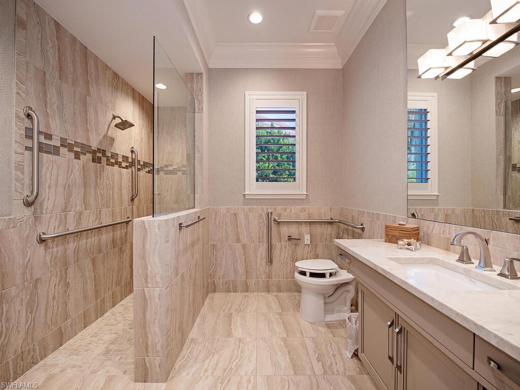 2835 Silverleaf Lane Naples, FL 34105 - Photo 28 of 47 a bathroom with a sink a toilet a mirror and shower