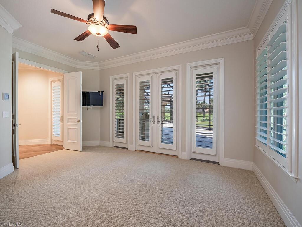 2835 Silverleaf Lane Naples, FL 34105 - Photo 32 of 50 a view of empty room with chandelier fan and window