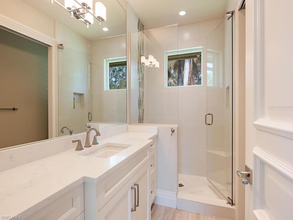 2835 Silverleaf Lane Naples, FL 34105 - Photo 36 of 50 a bathroom with a double vanity sink mirror and shower
