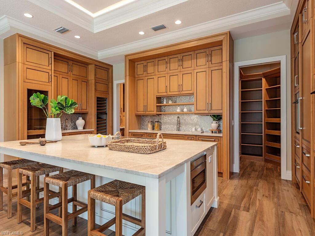 2835 Silverleaf Lane Naples, FL 34105 - Photo 9 of 47 a kitchen with stainless steel appliances granite countertop a stove and a wooden cabinets