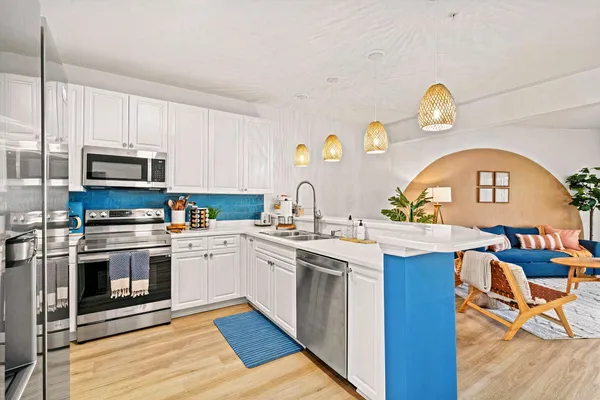a kitchen with stainless steel appliances granite countertop a stove and a sink