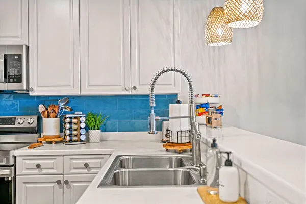 a kitchen with a sink and a stove top oven