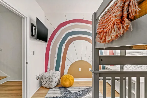 a view of a hallway with wooden floor and entryway
