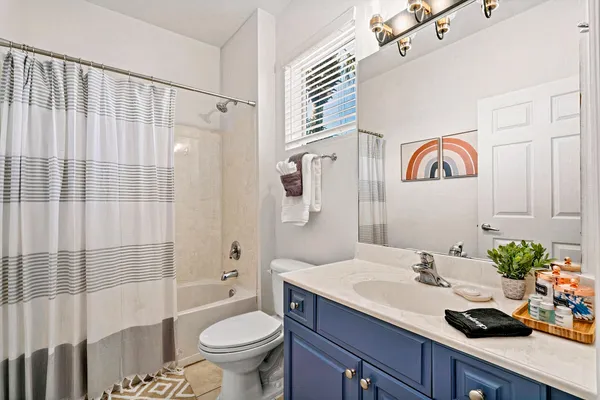 a bedroom with a bed and a view of kitchen