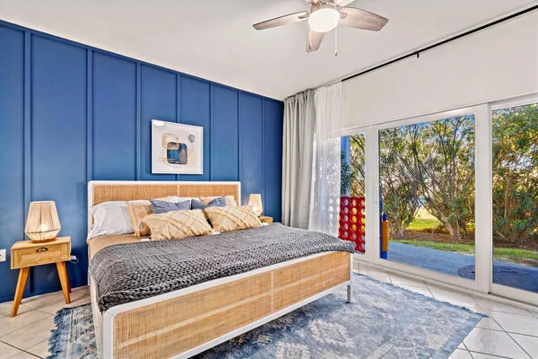 a bedroom with a large bed and a chandelier