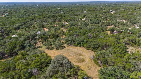a view of a city with lush green forest