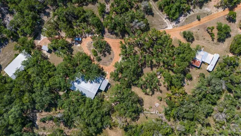 an aerial view of a house with a yard and outdoor space