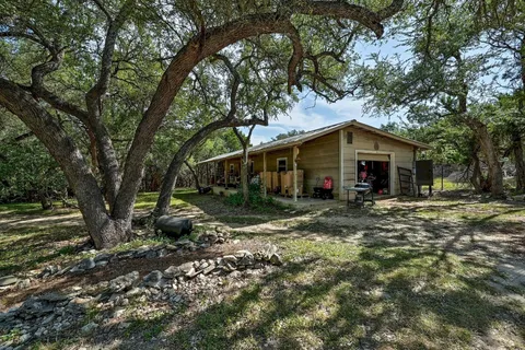 a view of a house with yard and tree s