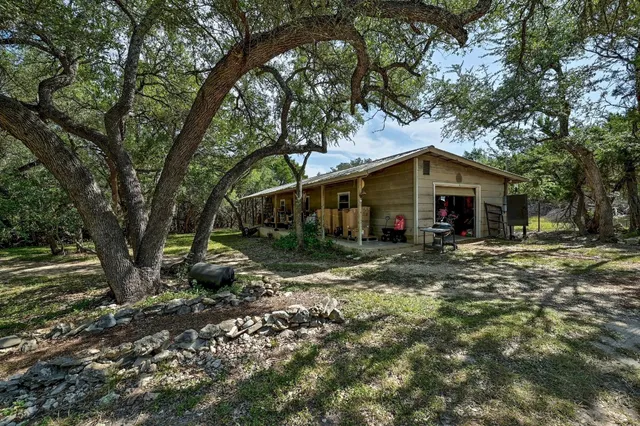 a view of a house with yard and tree s