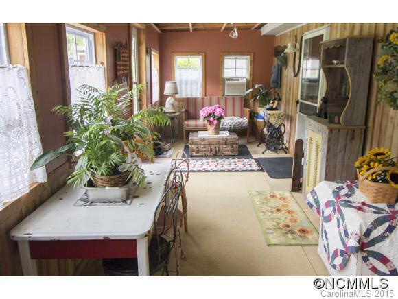 442 Van Arrington Road Clyde, NC 28721 - Photo 15 of 22 a view of living room with furniture and floor to ceiling window