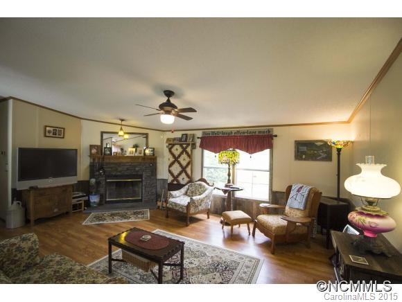 442 Van Arrington Road Clyde, NC 28721 - Photo 3 of 22 a living room with furniture a flat screen tv and a large window
