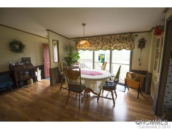 442 Van Arrington Road Clyde, NC 28721 - Photo 5 of 22 a view of a dining room with furniture window and wooden floor