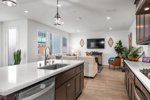a kitchen with sink stove and refrigerator