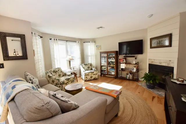 a living room with fireplace furniture and a flat screen tv