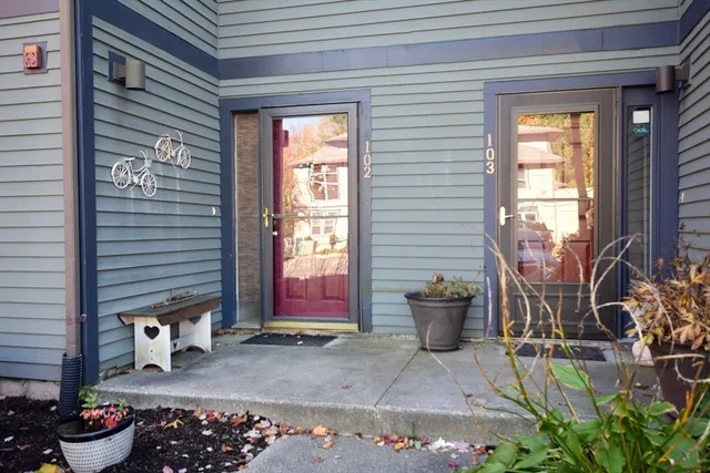 a building outdoor space with patio furniture and potted plants