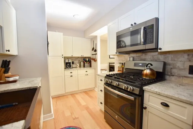 a kitchen with stainless steel appliances a refrigerator and cabinets