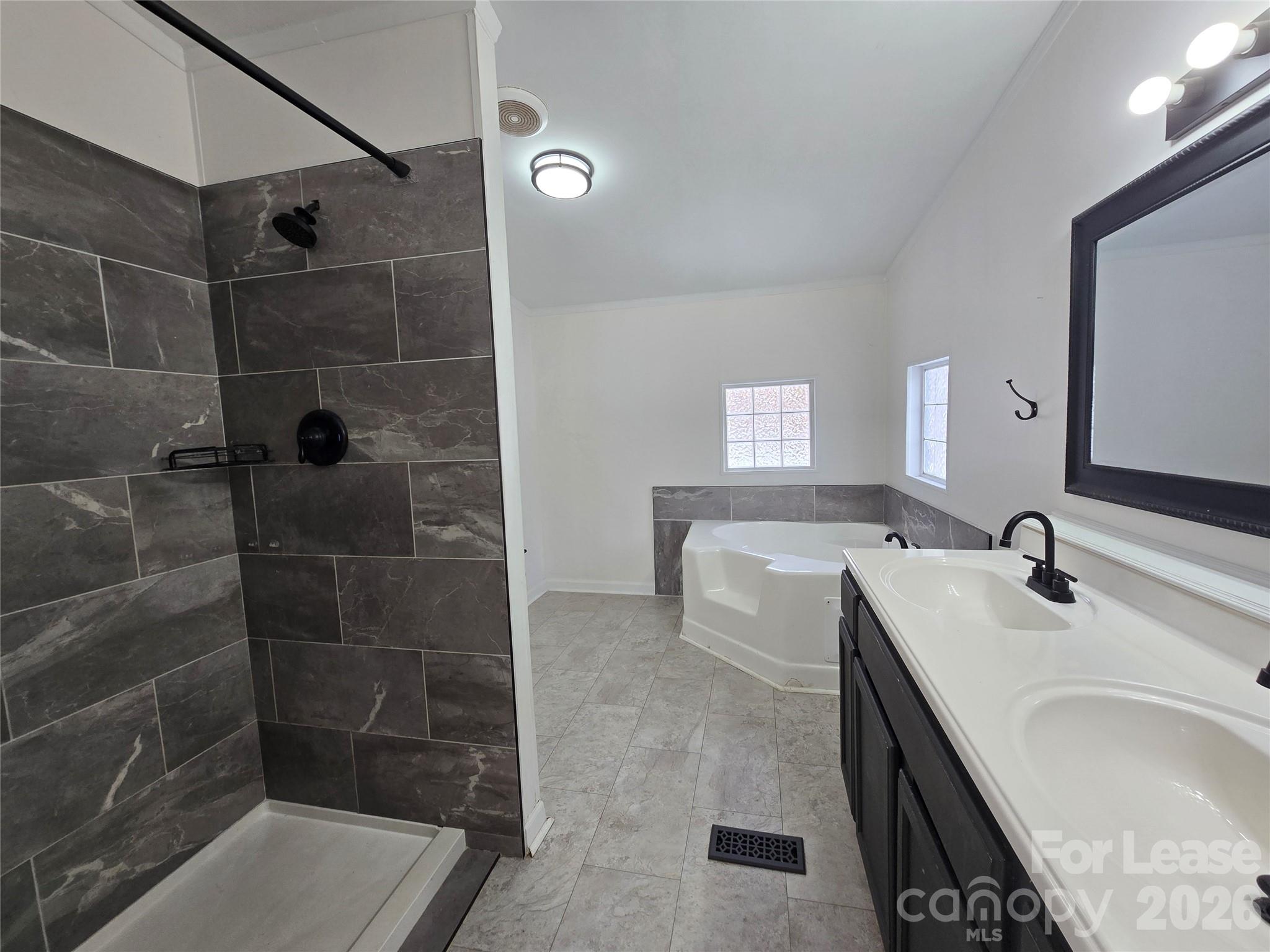 7133 Executive Circle Denver, NC 28037 - Photo 6 of 6 a bathroom with a granite countertop sink a toilet and shower