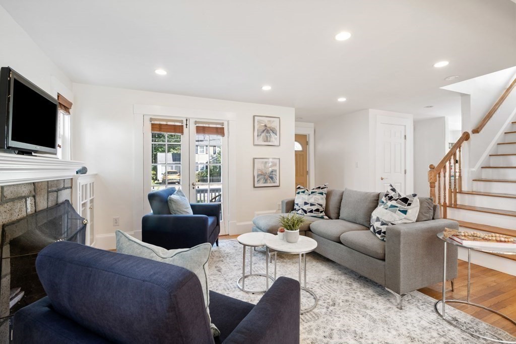 43 Hackensack Road Brookline, MA 02467 - Photo 12 of 24 a living room with furniture a flat screen tv and a fireplace