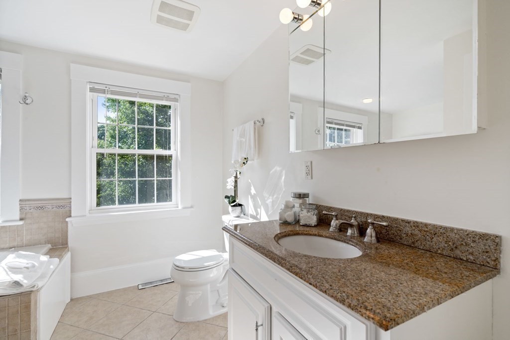 43 Hackensack Road Brookline, MA 02467 - Photo 19 of 24 a bathroom with a granite countertop sink a toilet and a window