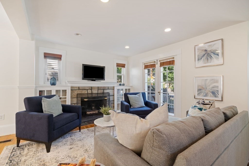 43 Hackensack Road Brookline, MA 02467 - Photo 10 of 24 a living room with furniture a fireplace and a flat screen tv