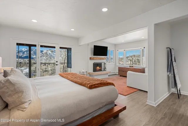 a bedroom with a large bed and a flat screen tv