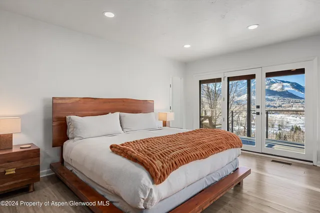 a bedroom with a large bed and a large window