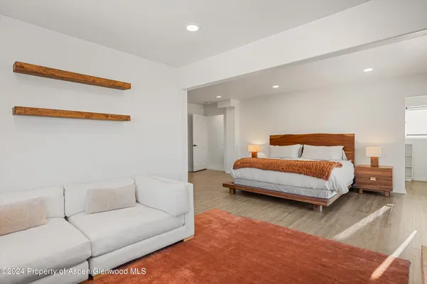 a bedroom with a bed and a couch