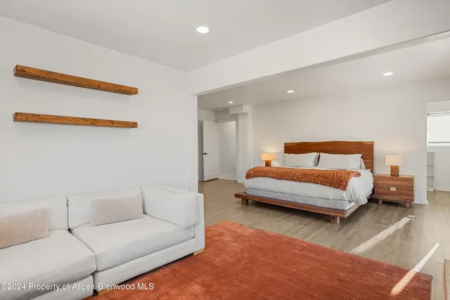 a bedroom with a bed and a couch