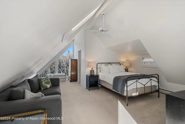 a bedroom with a bed and a couch